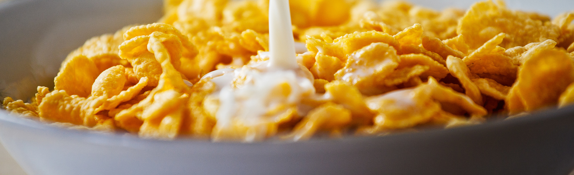 Milk being poured on cereal